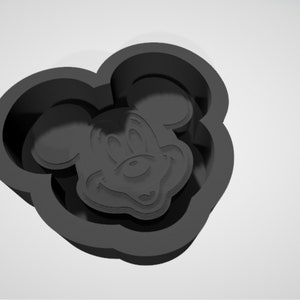 May include: Black silicone mold shaped like Mickey Mouse's head. The mold is designed to create cookies or other treats.