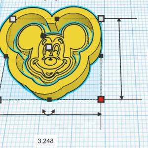 May include: Yellow plastic cookie cutter shaped like Mickey Mouse's head with a heart-shaped outline. The cutter is 3 inches tall and 3.248 inches wide.