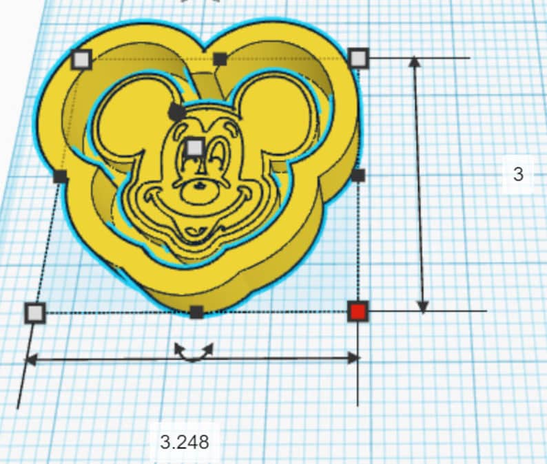 May include: Yellow plastic cookie cutter shaped like Mickey Mouse's head with a heart-shaped outline. The cutter is 3 inches tall and 3.248 inches wide.