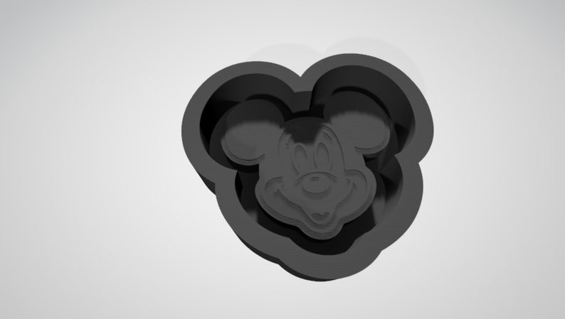 May include: Black plastic cookie cutter shaped like Mickey Mouse's head.