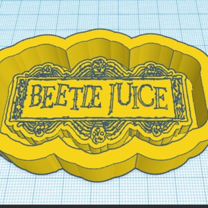 May include: Yellow plastic cookie cutter shaped like a banner with the words "Beetle Juice" in black text.