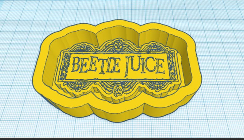 May include: Yellow plastic cookie cutter shaped like a banner with the words "Beetle Juice" in black text.