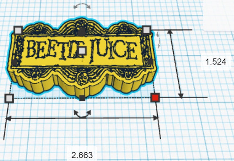 May include: A yellow 3D printed sign with a black border and the words "BEETLE JUICE" in black lettering. The sign is 6.76 cm wide and 3.87 cm tall.