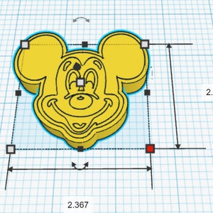 May include: A yellow 3D printed model of Mickey Mouse's head. The model is 2.367 inches wide and 2.117 inches tall.