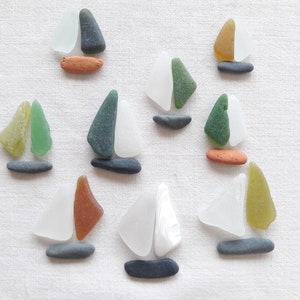 Pebbles, pottery fragments, polished sea glass and dishes. Sailboats, Supply for mineral board, Pebble art.