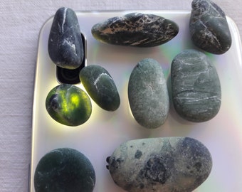 Serpentinite polished naturally by the sea, Pebbles with green reflections,