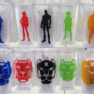 May include: Set of ten clear plastic tumblers with various coloured graphic designs. The designs include silhouettes of characters and lions.