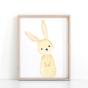 May include: A watercolor painting of a light brown bunny rabbit with pink ears. The bunny is standing on its hind legs with its front paws crossed. The bunny is looking at the viewer with a friendly expression.