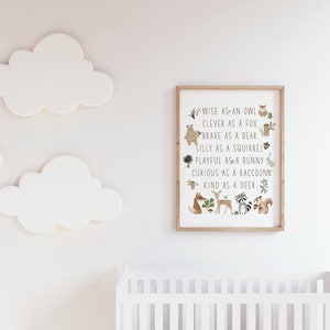 May include: A framed nursery print with a white background and brown wood frame. The print features a circle of woodland animals with text that reads "Wise as an owl, Clever as a fox, Brave as a bear, Silly as a squirrel, Playful as a bunny, Curious as a raccoon, Kind as a deer."