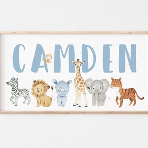 May include: A light blue personalized name sign with the name "CAMDEN" in large letters. The name is surrounded by a row of watercolor animal illustrations including a zebra, lion, rhinoceros, giraffe, elephant, and tiger.