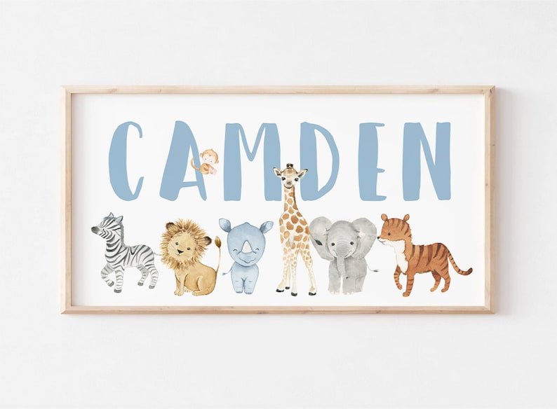 May include: A light blue personalized name sign with the name "CAMDEN" in large letters. The name is surrounded by a row of watercolor animal illustrations including a zebra, lion, rhinoceros, giraffe, elephant, and tiger.