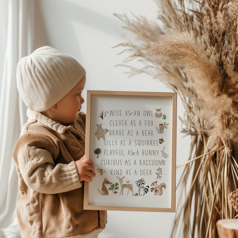 May include: A framed print with a white background and brown frame. The print features a list of animal adjectives, such as "wise as an owl" and "clever as a fox", with illustrations of each animal.
