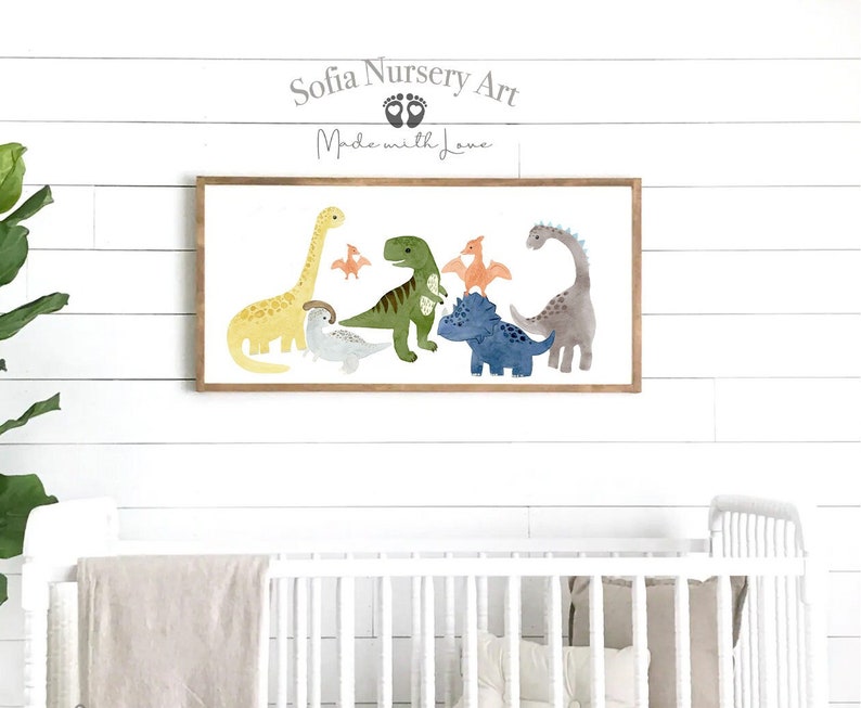Pode incluir: Uma impress&atilde;o em aquarela emoldurada que apresenta um grupo de dinossauros em v&aacute;rias cores, incluindo verde, azul, amarelo e laranja. A impress&atilde;o tem um fundo branco e uma moldura de madeira. O texto "Sofia Nursery Art" e "Made with Love" est&aacute; impresso sobre os dinossauros.