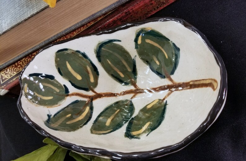 Small artisan made stoneware jewelry dish with hand painted leaf design
