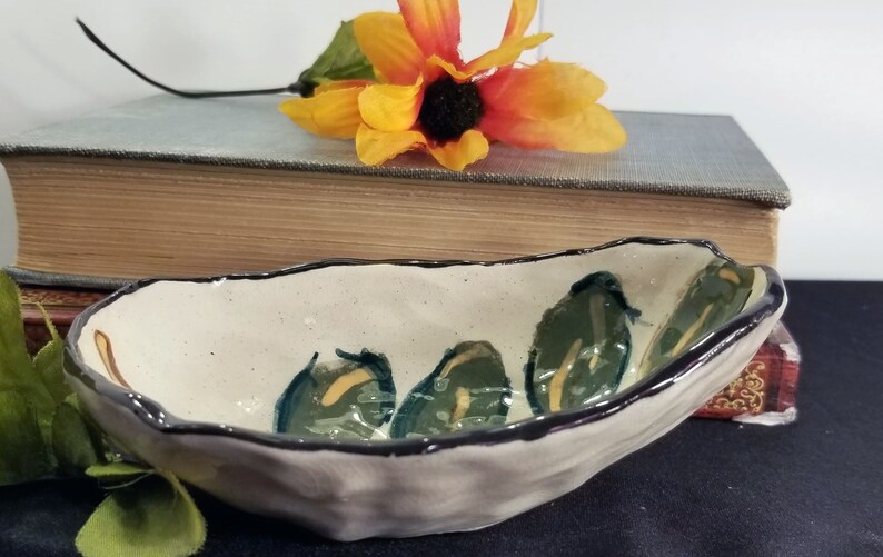 Small artisan made stoneware jewelry dish with hand painted leaf design
