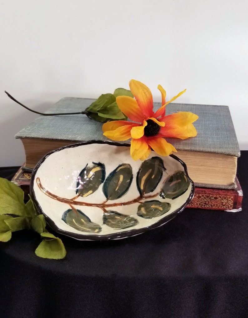 Small artisan made stoneware jewelry dish with hand painted leaf design