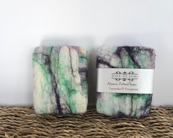 May include: Two bars of alpaca felted soap, one with a green and purple swirl pattern and the other with a label that reads "Joyo de Suri Alpaca-Felted Soap Lavender & Evergreen".