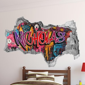 May include: A bedroom with a red dresser, a wooden bed with a striped comforter, and a wall decal that says "NICHOLAS" in colorful graffiti letters.