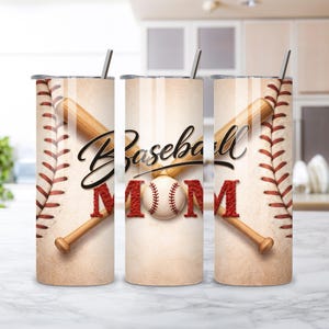 May include: A stainless steel tumbler with a baseball theme. The design features a baseball, crossed bats, and the words "Baseball MOM" in black and red. The tumbler has a silver straw and lid.