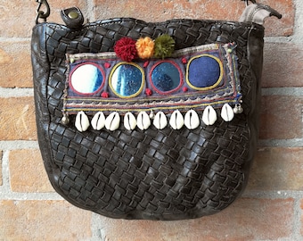 Braided leather bag with Banjara mirror embroidery, pompons and cowrie shells