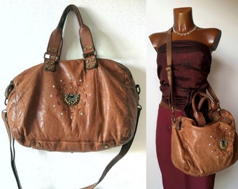 Leather bag with studs and kuchi pendant, zippers and shoulder strap, tobacco color