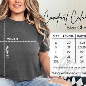 May include: A dark gray boxy t-shirt with a size chart. The chart shows measurements in inches for sizes S to 2XL. The text "Comfort Colors" and "3023CL WOMENS BOXY T-SHIRT" are also visible.