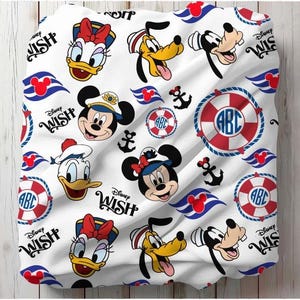 May include: White fabric featuring a repeating pattern of Disney characters including Mickey Mouse, Minnie Mouse, Donald Duck, Daisy Duck, and Goofy. The design also includes anchors, life preservers, and the text "Disney Wish".
