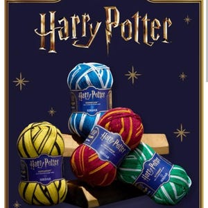 May include: Four skeins of Harry Potter branded yarn by Sirdar, featuring Hufflepuff yellow and black, Ravenclaw blue and white, Gryffindor red and gold, and Slytherin green and white stripes, all displayed against a dark blue background.