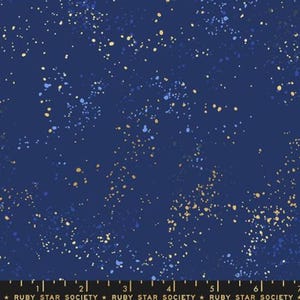 May include: Navy blue fabric with a speckled pattern of gold and light blue dots. The fabric has a dark blue background and a repeating pattern. The text "RUBY STAR SOCIETY" is at the bottom.