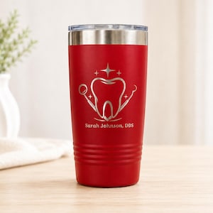 May include: A red insulated tumbler with a silver lid. The tumbler features a dental-themed design with a tooth, dental tools, and the name "Sarah Johnson, DDS" in silver. The tumbler is designed to keep beverages hot or cold.