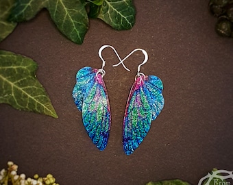 Small training wings. Small blue sparkle fairy wing earrings on a choice of ear wires.