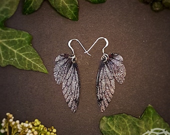 Small training wings. Small silver and black sparkle fairy wing earrings on a choice of earwires.