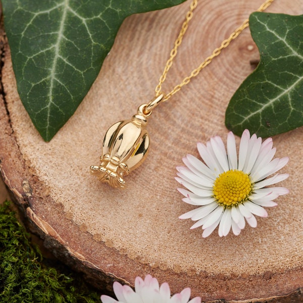 Gold poppy seed pod necklace.