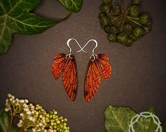 Small training wings. Small bronze sparkle fairy wing earrings on a choice of ear wires.