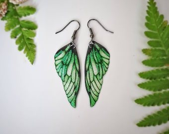 Green glitter fairy wing earrings.