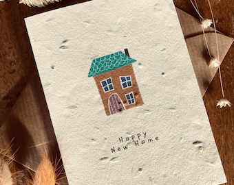 Tarjeta de felicitación para un nuevo hogar hecha de papel con semillas plantables.