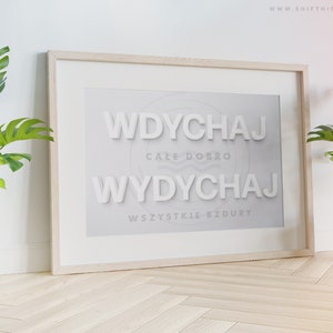 May include: A framed print with the text "Wdychaj cale dobro Wdychaj wszystkie bzury" in white letters on a light grey background.