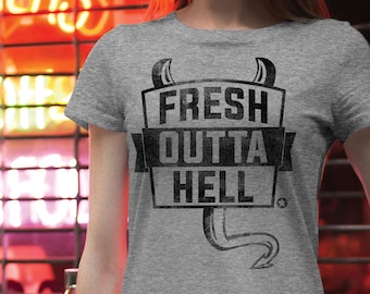 May include: A gray t-shirt with a black graphic print that says "Fresh Outta Hell" with a devil tail and horns.