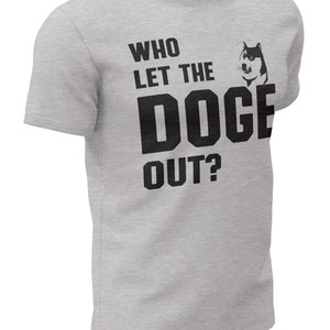 May include: A grey t-shirt with a black graphic that says "Who let the Doge out?" with a cartoon Shiba Inu dog image.
