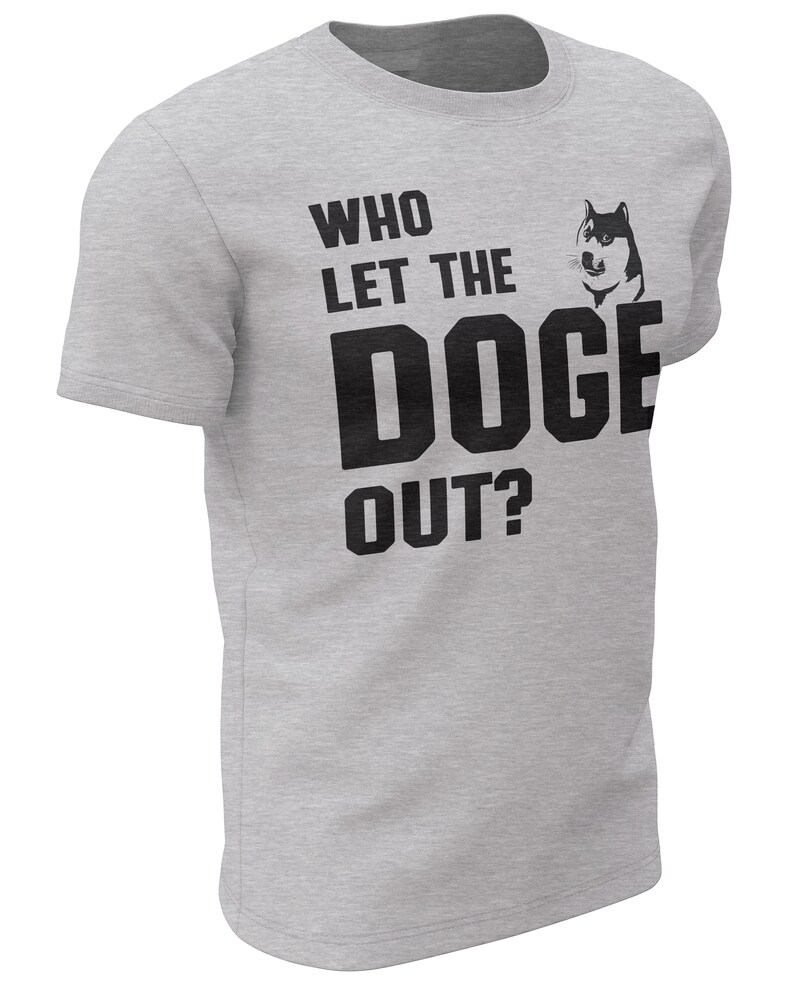 May include: A grey t-shirt with a black graphic that says "Who let the Doge out?" with a cartoon Shiba Inu dog image.