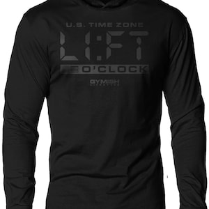 May include: Black long-sleeve hooded shirt with a digital clock graphic that reads "U.S. TIME ZONE LIFT 0'CLOCK" and the text "GYMISH LIFESTYLE" below the clock.