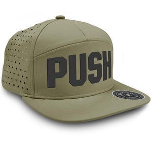 May include: A green and black baseball cap with the word "PUSH" in large black letters on the front. The cap has a mesh panel on the back and a small black and white label on the side.