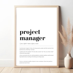 May include: A black and white printable poster with a definition of a project manager. The text reads: "project manager (pra.dzekt 'mæn.1.dzər), noun A professional wrangler of chaos who keeps projects, people, and their emotions from spontaneously combusting-most days. A patient saint who translates "It'll only take a minute" into "See you in three weeks" without throwing a stapler. A brave soul armed with color-coded spreadsheets, unrealistic deadlines, and the eternal hope that this time everything will actually go according to plan. See also: task herder, deadline whisperer, chaos coordinator, Gantt chart gladiator, professional email chaser"