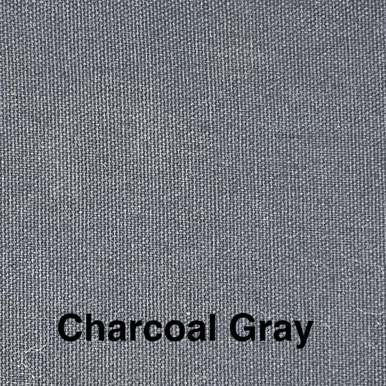 May include: Close-up of a textured fabric in charcoal gray. The weave is visible, creating a subtle pattern. The words "Charcoal Gray" are printed in a bold, black font at the bottom of the image.