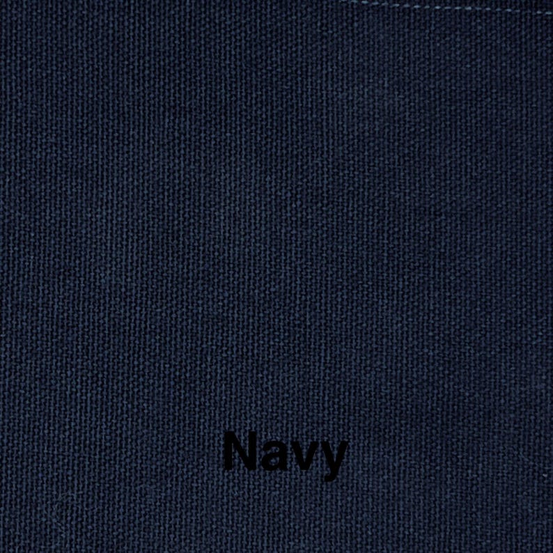 May include: Close-up of a navy blue fabric with a textured weave. The word "Navy" is printed in black at the bottom of the image. The fabric appears to be a solid color.