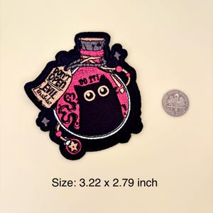 May include: Embroidered patch featuring a black cat inside a pink potion bottle. The patch includes the text "DON'T OPEN EVIL inside" and "DO IT!" The patch measures 3.22 x 2.79 inches.