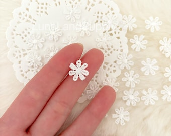 May include: White lace flower embellishments, perfect for adding a delicate touch to crafts and clothing projects.