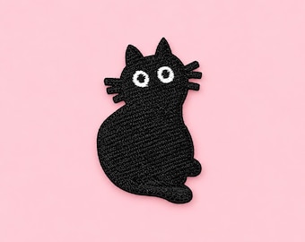 May include: An embroidered patch in the shape of a black cat. The cat has a rounded body, pointed ears, and three whiskers on each side of its face. It features two large, circular white eyes with black pupils, creating a wide-eyed expression.