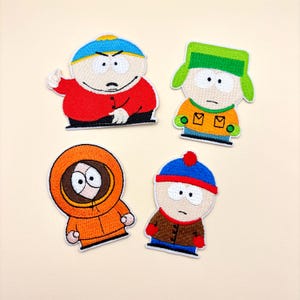 May include: Four embroidered patches featuring the characters Eric Cartman in a red jacket, Kyle Broflovski in a green hat and orange coat, Kenny McCormick in an orange parka, and Stan Marsh in a blue hat and brown coat from South Park.