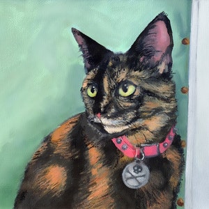 May include: A tortoiseshell cat with green eyes, wearing a pink collar with a silver tag, is looking to the right of the frame. The cat is painted in a realistic style against a light green background.